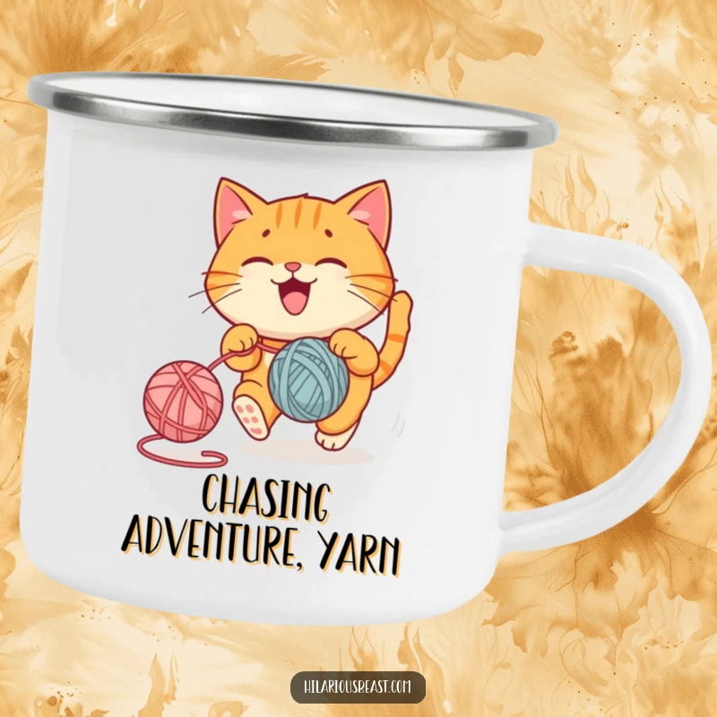 Funny camping mug with a round orange cat joyfully chasing a bouncing yarn ball, a functional funny gift.