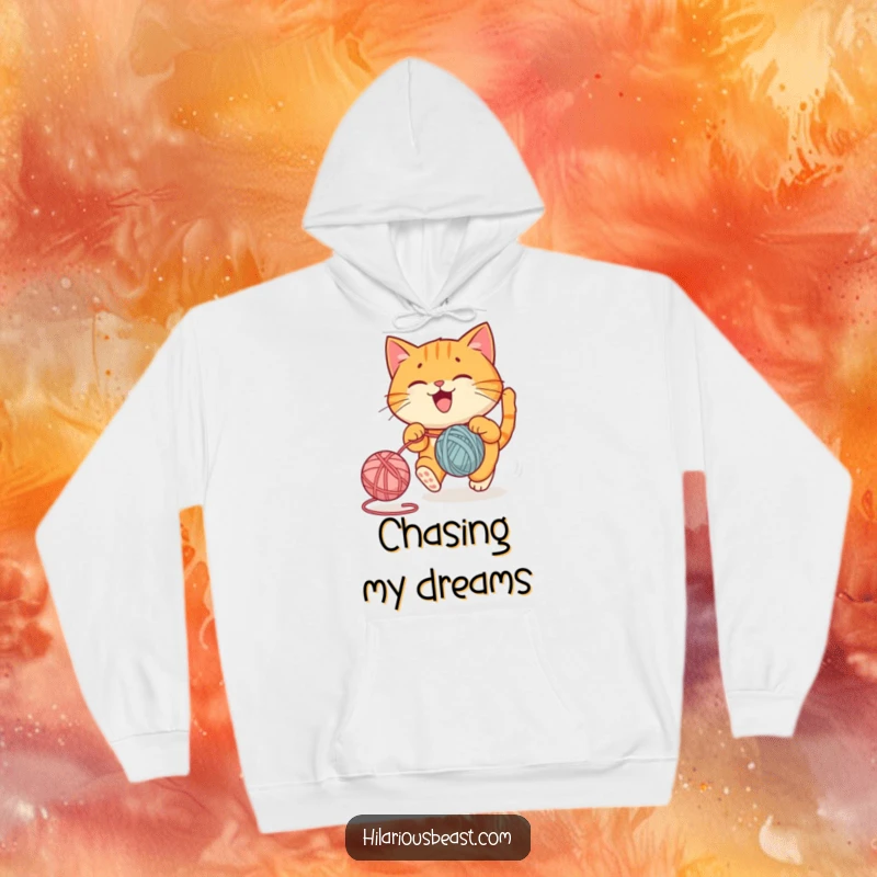 Funny hoodie depicting a round orange cat joyfully chasing a bouncing yarn ball, a cozy funny gift.