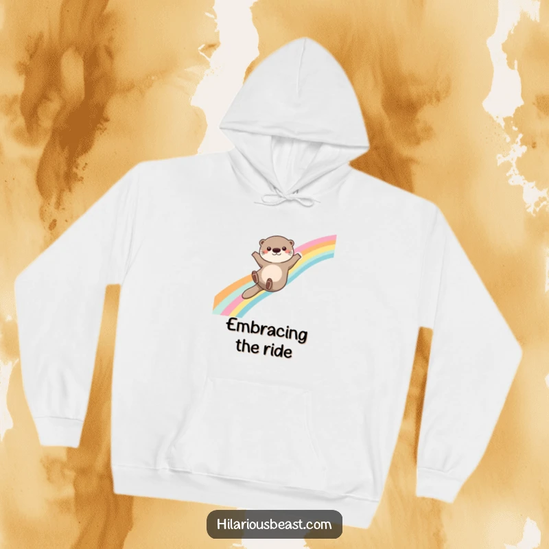 Funny otter hoodie featuring a cute otter sliding down a rainbow, arms outstretched for balance, offering magical warmth and cheer.
