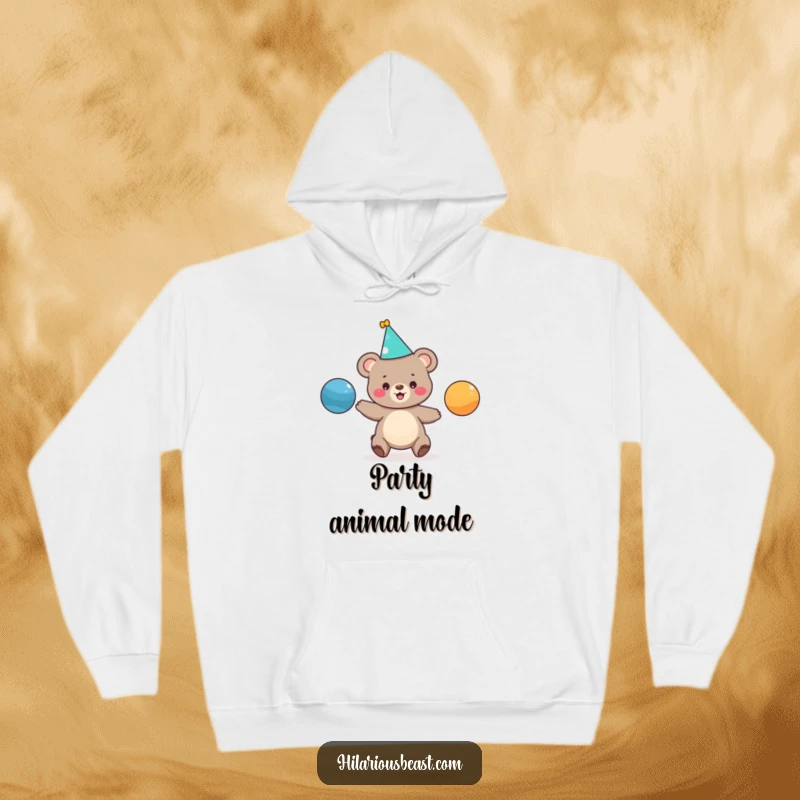 Funny hoodie graphic of a cute bear cub in a party hat, enthusiastically juggling colorful balls, designed for ultimate comfort and humor.
