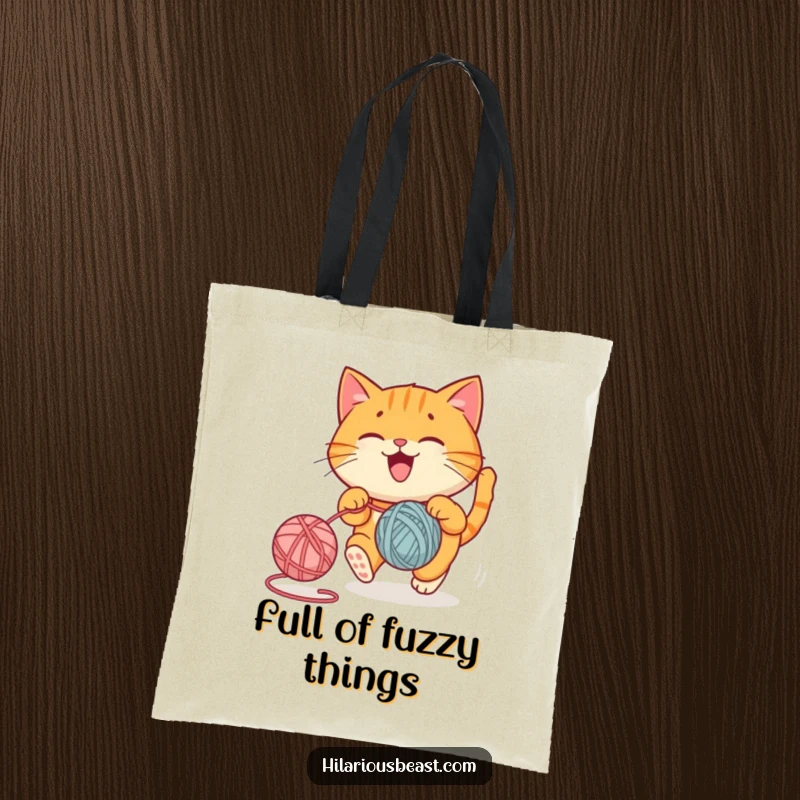 Funny tote bag featuring a round orange cat joyfully chasing a bouncing yarn ball, a whimsical funny gift.